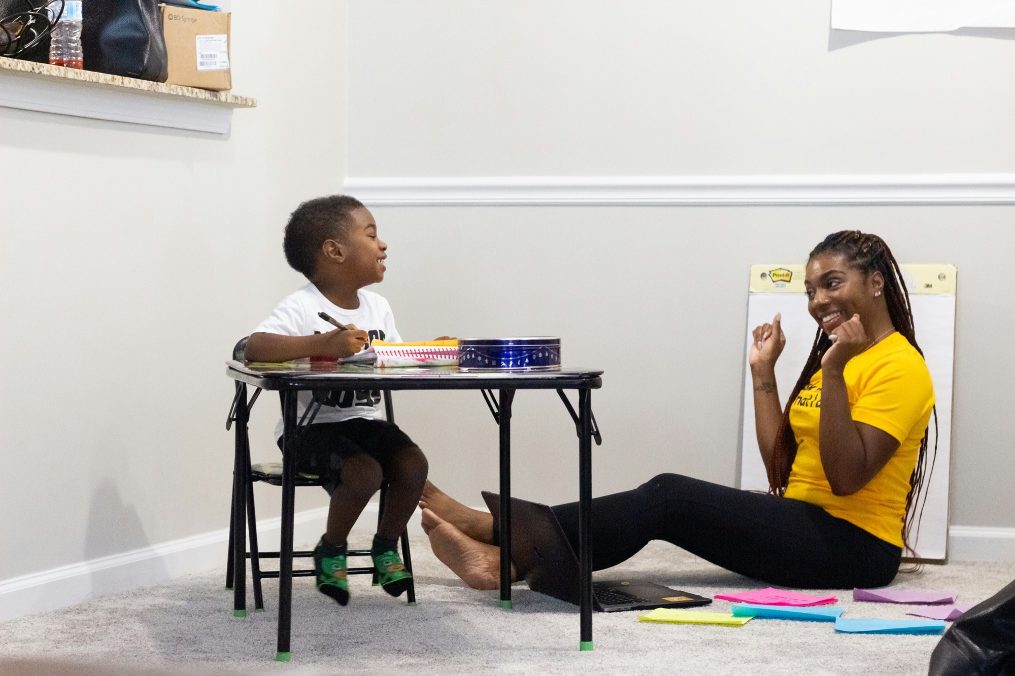 A clinician and a child working together at a small table