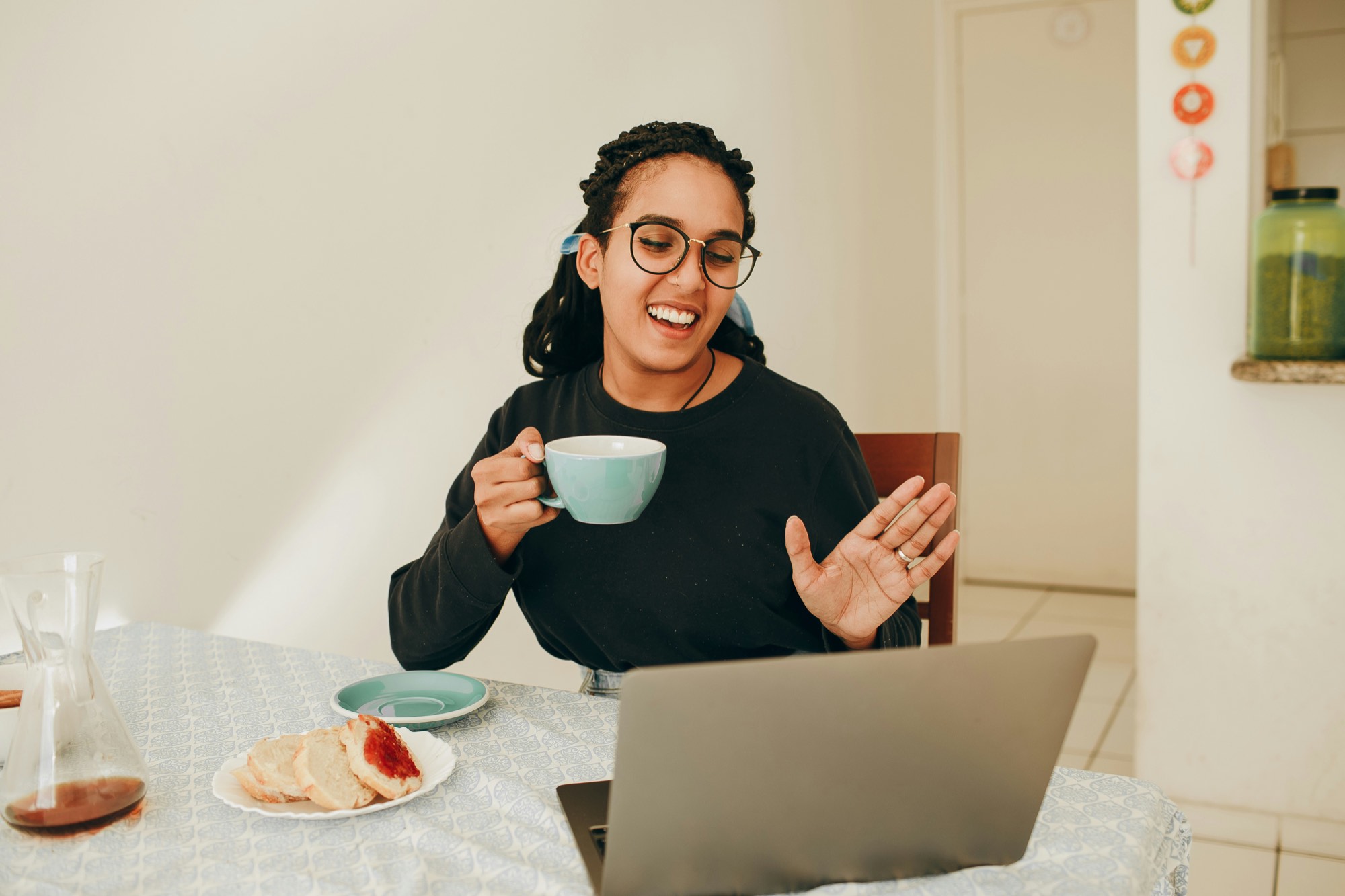 A learner smiling while following an online module on a laptop